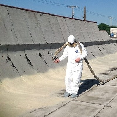 A Roofer Sprays on Foam Roofing