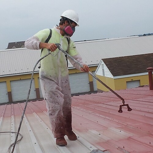 A Contractor Applies a Roof Coating.
