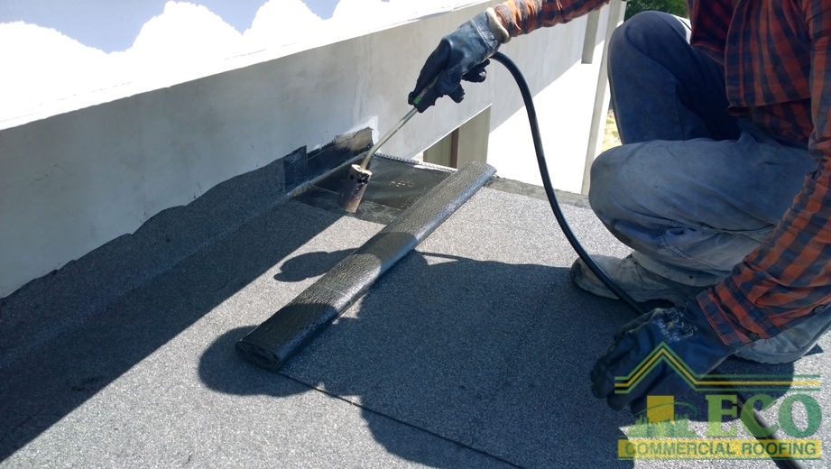 Roofer Preparing Bitumen Roofing Felt
