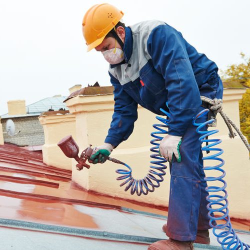 Roof Applying Pulverizer Spray Paint on Metal Sheet Roof