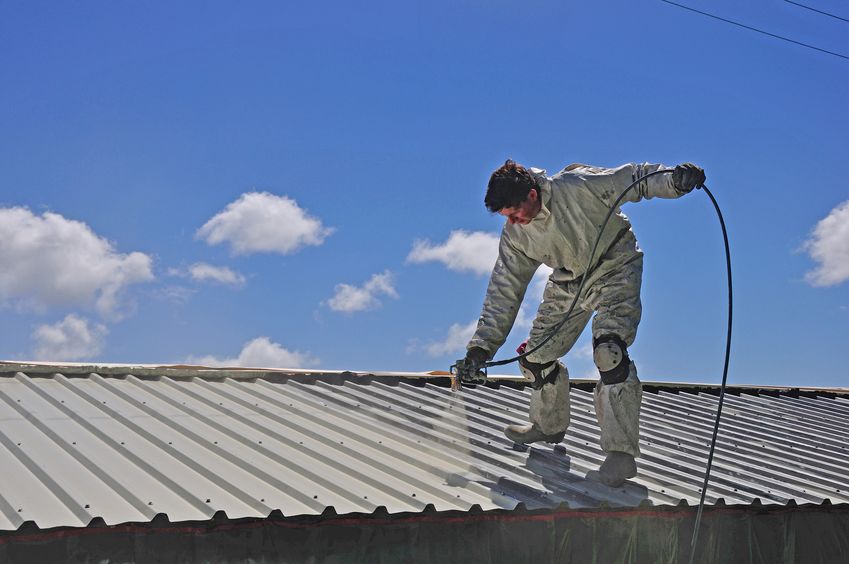 Roofer Applies Airless Spray to Building